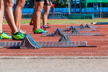 Runner feet on track -sprint start in track.