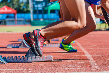 Runner feet on track -sprint start in track.