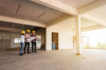three construction engineers working together in side building