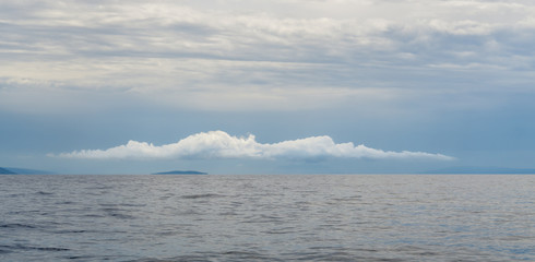 A lone cloud hovers over one of Croatia's Pakleni Islands, a popular tourist destination near Hvar Island.