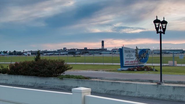 US Coast Guard Reconnaissance Airplane Landing at Louis Armstrong New Orleans International Airport in Louisiana USA at Dusk with Sunset Colors in the Background Sky