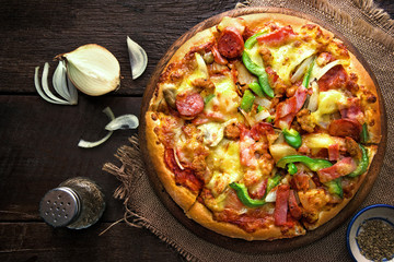 pizza on a rustic wooden table. Top view