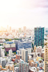 Fototapeta na wymiar Asia Business concept for real estate and corporate construction - vertical modern cityscape building bird eye aerial view from tokyo tower under sunrise and morning blue bright sky in Tokyo, Japan
