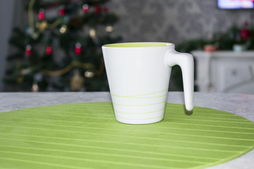 White Cup with handle for tea on Christmas background