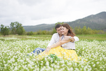 Fototapeta na wymiar Lovers meet men and women on a beautiful flower field.