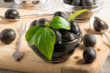 Foto op Plexiglas Black olives on a table and glass cups with oil © romensky