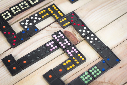Dominoes game pieces on wood background.