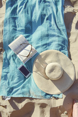 beach background with hat and towel