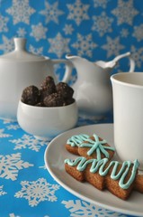 Tea set with cookies and sweets on blue background