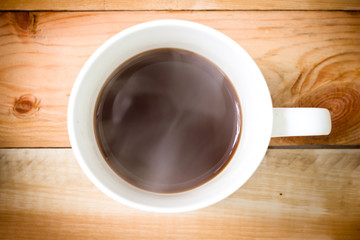 Coffee cup top view on wooden table.