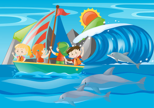 Kids sailing and dolphin in the ocean