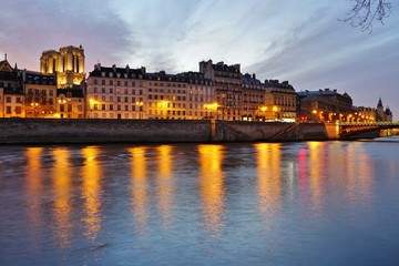 Fototapeta na wymiar Beautiful pink sky at sunset over the Notre-Dame cathedral and the Seine River in Paris, France