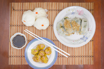 Steamed stuff bun (Salapao) and dumpling on mat bamboo.