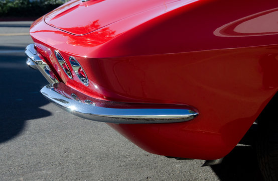 Elements of a red classic car parked in Southern California vill