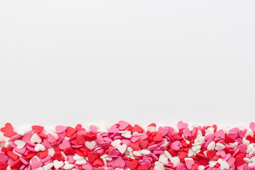 many little hearts at the bottom on a white background. festive background for Valentine's day, birthday, holiday