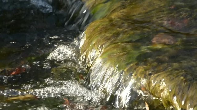 Mountain creek, stream, small waterfall (sunny day) - flowing running water background
