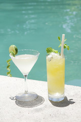 Refreshing drinks next to the pool, summer vacation concept