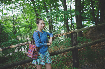 Naklejka na ściany i meble Young girl on a walk in the forest
