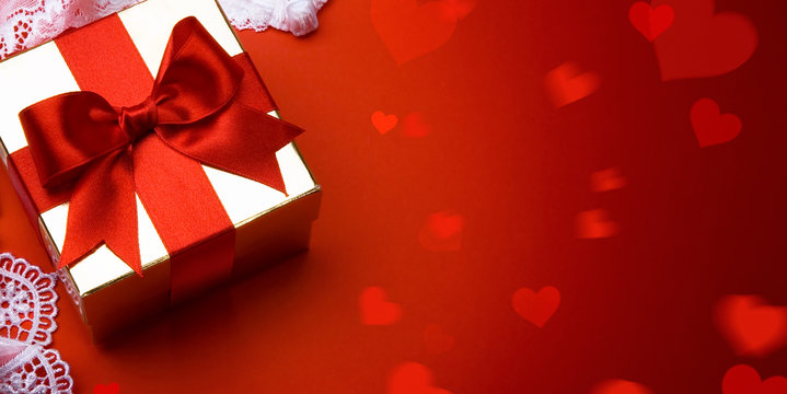 Art valentine day; golden gift box on red background