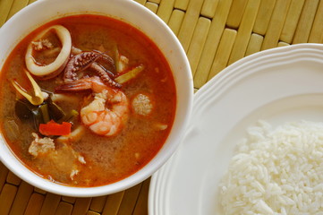 boiled seafood and pork tom yum Thai spicy soup eat with rice
