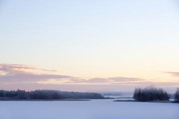 Fototapeta premium Sunrise on a winter morning. Fog is covering the landscape.