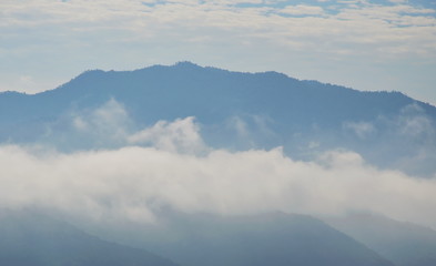 cloudy and mist floating cover mountain in sunny day