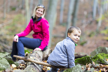 Woman and child on a hike in the woods.