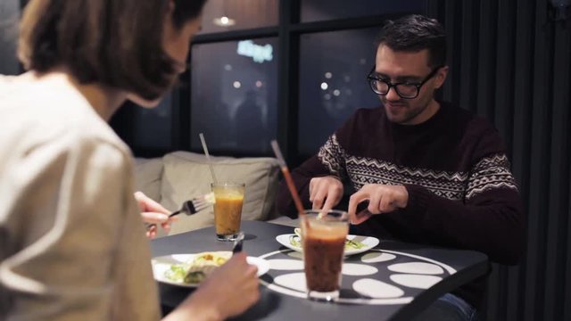 happy couple having dinner at vegan restaurant