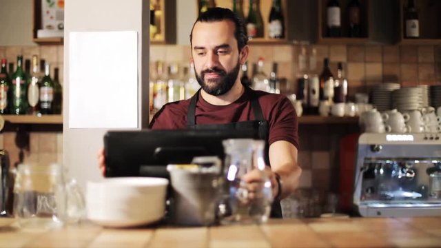 happy man or waiter at cashbox in coffee shop