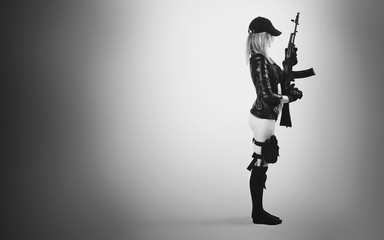 Fototapeta na wymiar sexy girl in black lingerie with assault rifle
