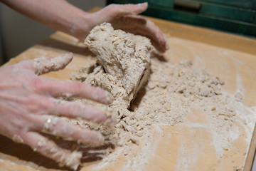 hands kneading cake dough