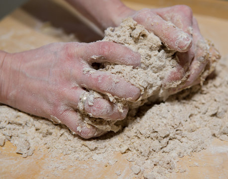hands kneading cake dough