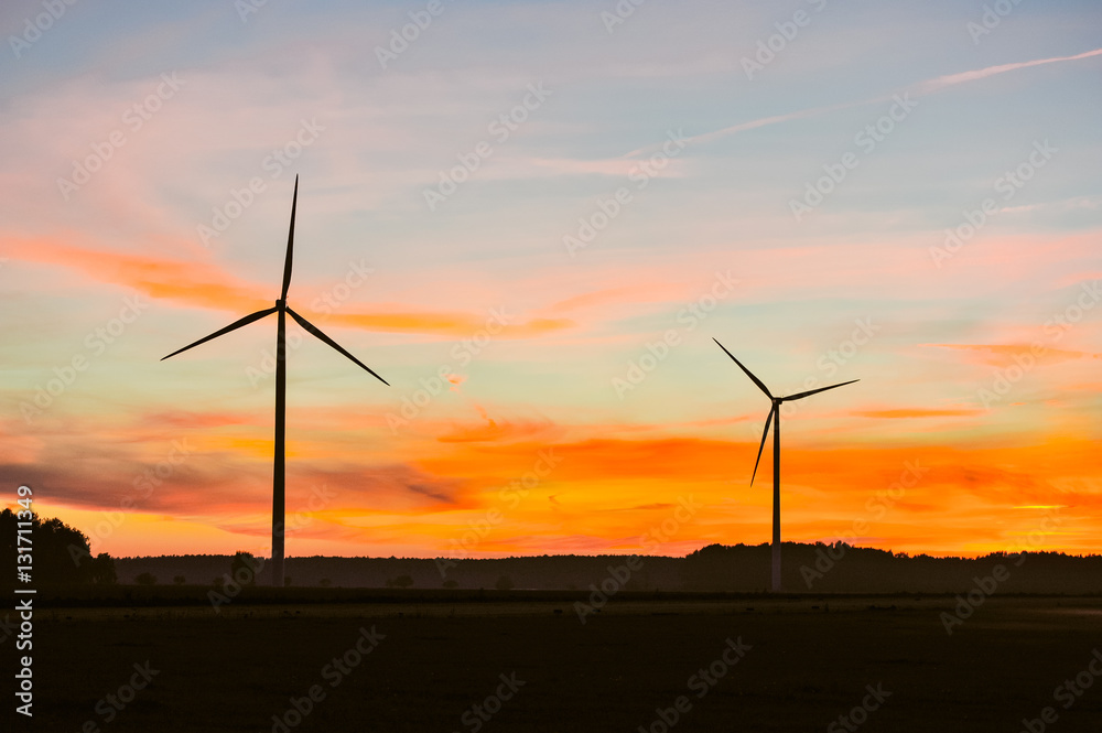 Wall mural silhouette of wind turbine on sunset