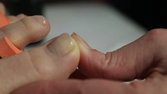 Woman getting pedicure in nail salon
