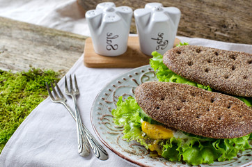 Healthy food - sandwiches of dark bread and poached eggs.