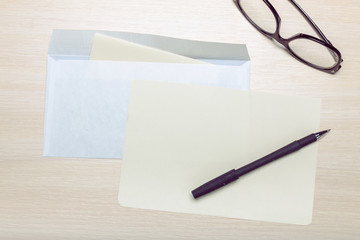 Photo of blank envelope on a  wooden background