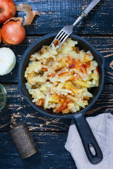 Fried potatoes with onions in cast-iron frying pan