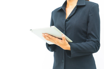 Business woman in dark suit using her tablet on white background with copy space