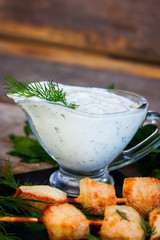 Greek sauce with natural yogurt, cucumbers and herbs, selective focus