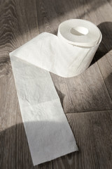 Toilet paper on wood background