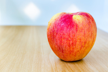Red apple on wooden table