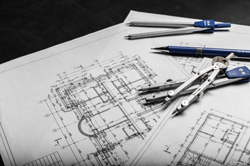 Construction planning drawings on black background