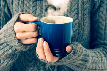 blue cup in woman's hands