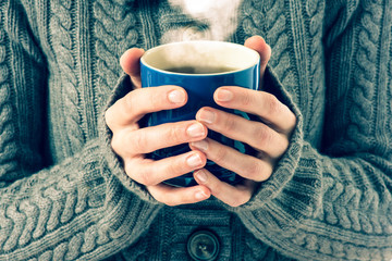 blue cup in woman's hands