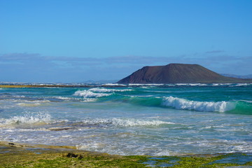 Fototapeta na wymiar Turquoise ocean on sand dunes Fuerteventura, Corralejo, Canary Islands