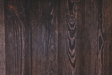 Dark brown wooden background. Texture. Top view.