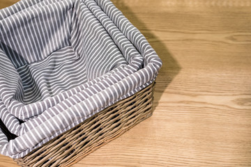 Fototapeta na wymiar woven bamboo basket covered with grey and white stripe cloth