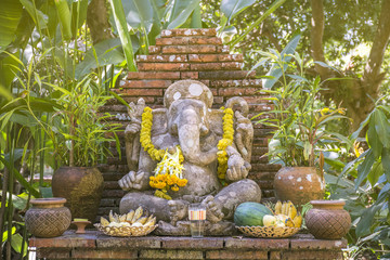 Religious stone sculpture of Ganesha god in garden, Thailand. Sc