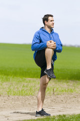 man stand and stretch the leg