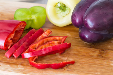 assortment of pepper (paprika) on wooden cutting board